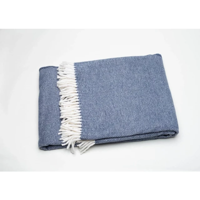 Blue mini dot fringed throw blanket made of natural woolen material with a pattern