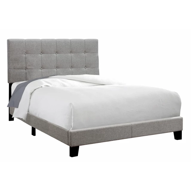 Full grey linen bed in a modern bedroom setting