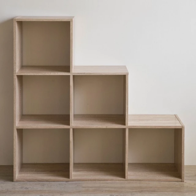 Natural finish six cubby stepped bookcase in wood with shelving and cabinetry design