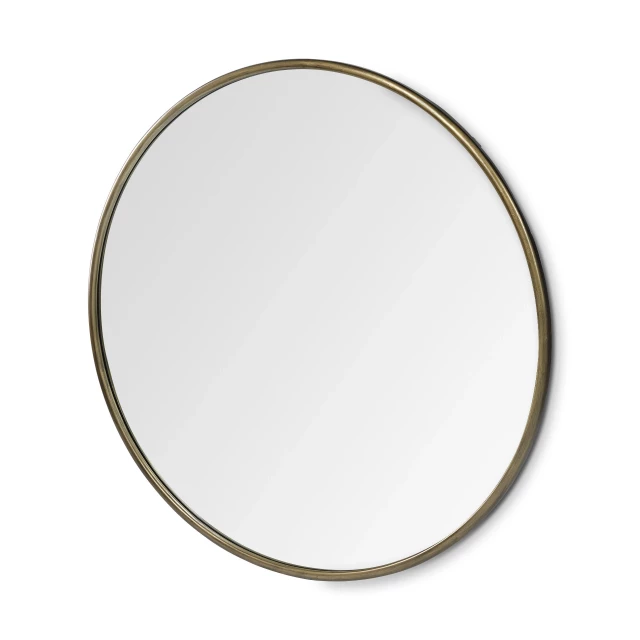 Round gold metal frame wall mirror as a fashionable home accessory with a hint of jewellery element