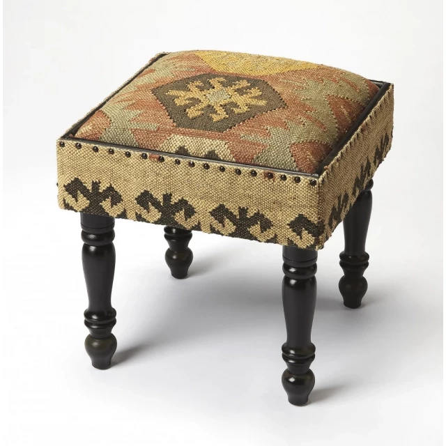 Brown linen ottoman with metal accents resembling furniture wheel design