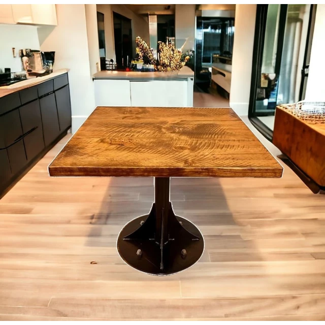 Wood steel pedestal base dining table in well-lit interior with rectangle wood top and cabinetry design