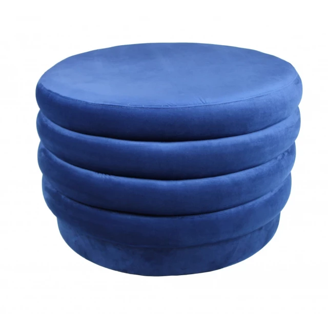 Blue velvet tufted round cocktail ottoman in electric blue color with detailed stitching and plush upholstery