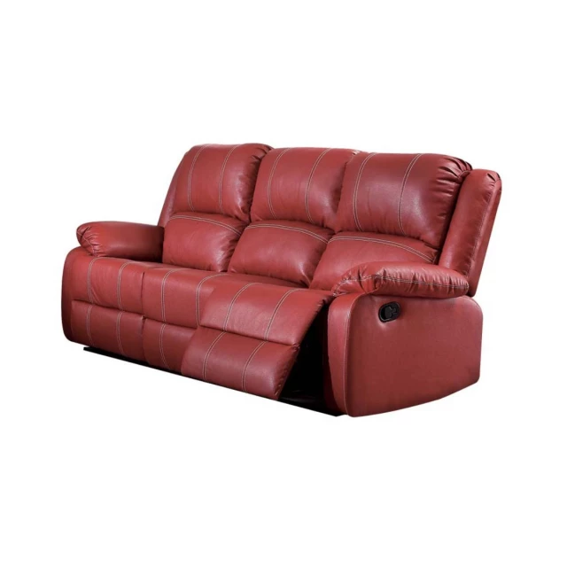 Red black faux leather reclining sofa with pillows and wood accents in a comfortable furniture setting