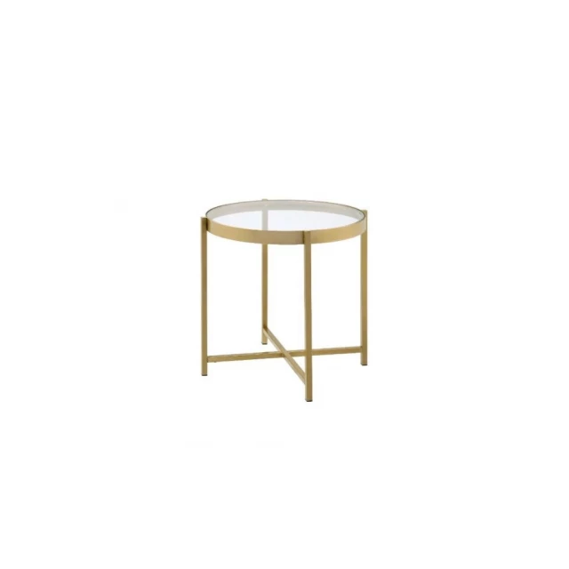Clear glass metal round end table with circular top and rectangle chair in background