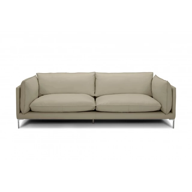 taupe grain leather sofa with wood accents in a natural outdoor setting