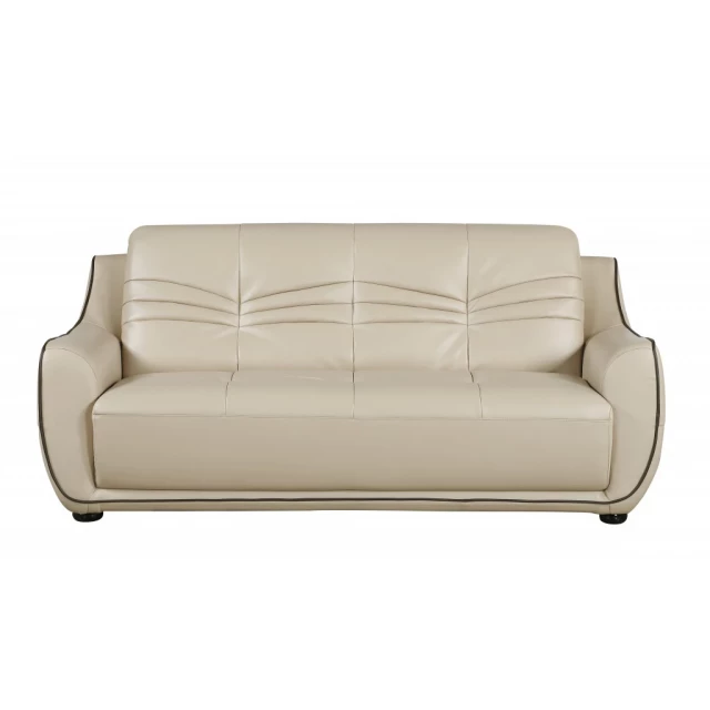Beige brown leather sofa in a modern style with comfortable cushions and wooden legs