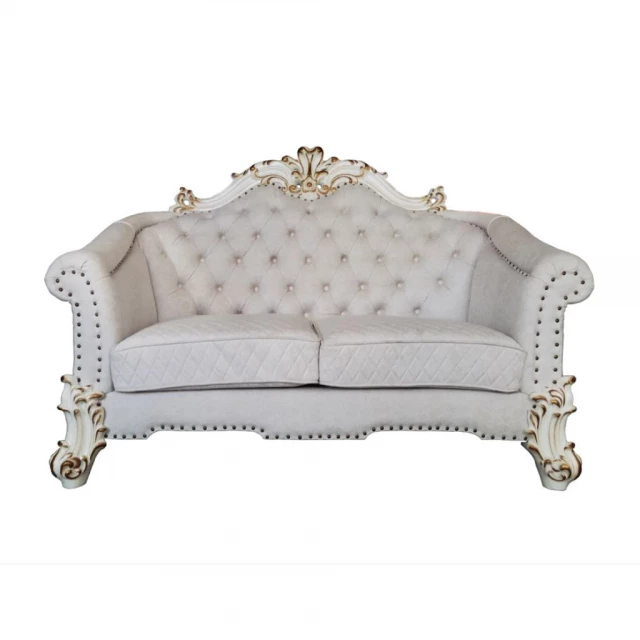 Ivory pearl velvet loveseat with toss pillows in a comfortable studio couch design