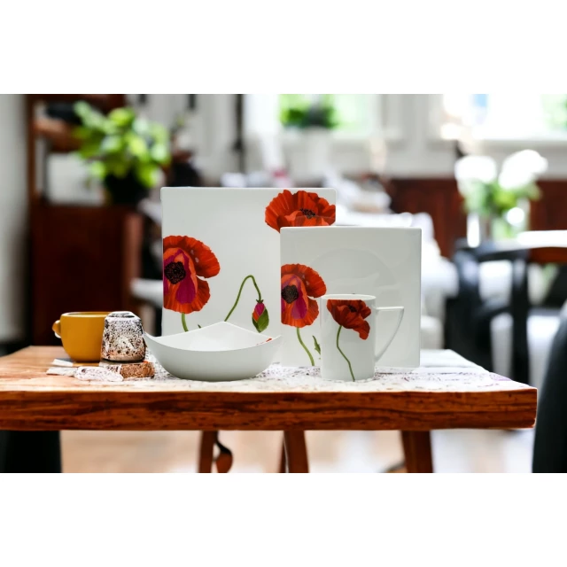 Four square floral bone china dinnerware set with flower petal design on table