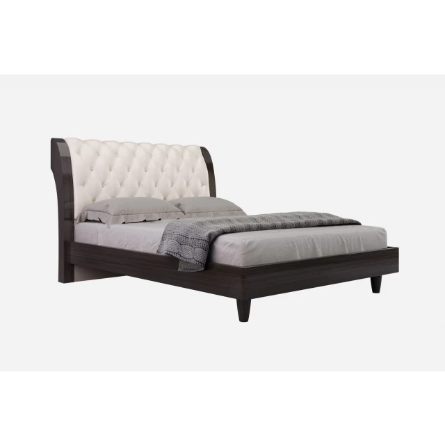 Upholstered faux leather bed with nailhead trim in elegant bedroom setting