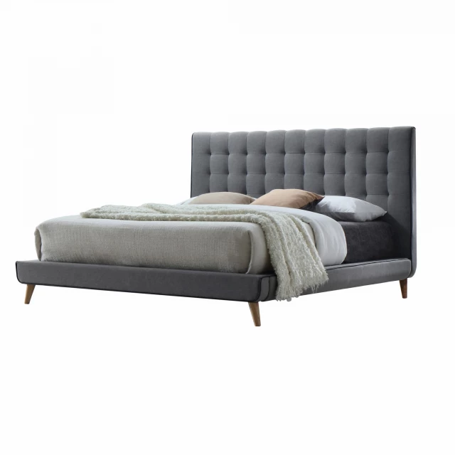 Gray light gray upholstered linen bed in a bedroom setting
