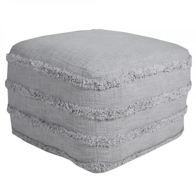 Gray cotton ottoman with fashion accessory elements in a styled setting