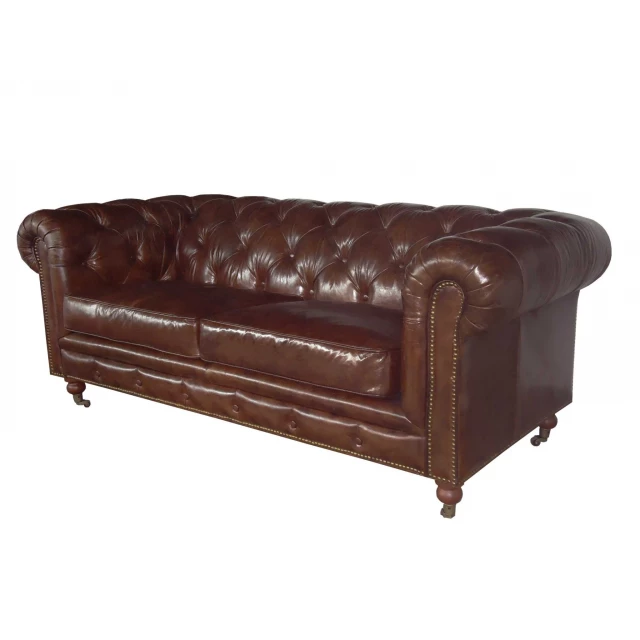 Brown leather chesterfield sofa with comfortable armrests and rectangle futon pad