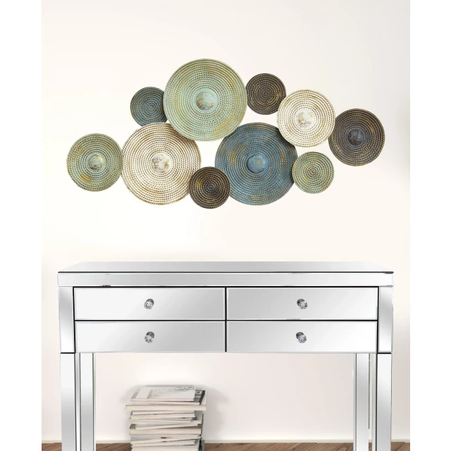 textured metal plates wall decor on white dresser with cabinetry and shelving in background