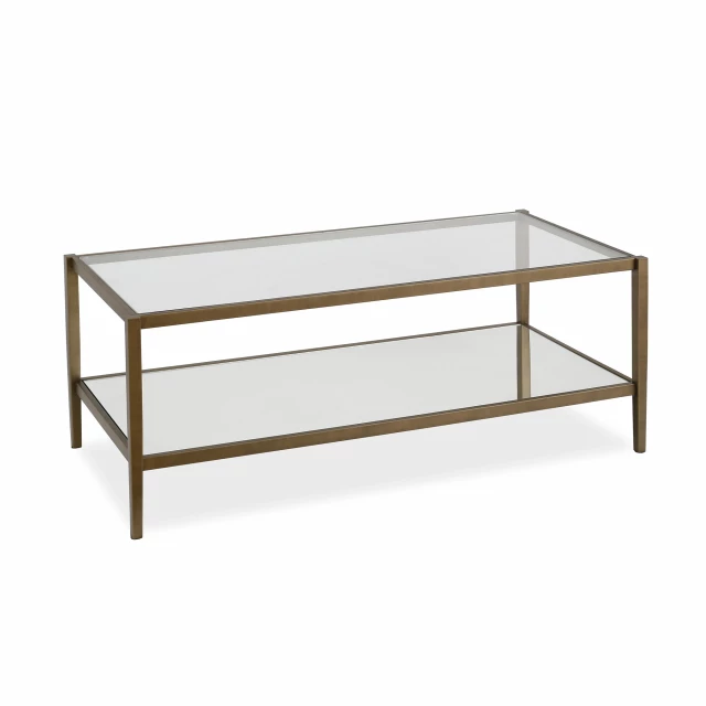 Gold glass steel coffee table with shelf in a natural wood setting
