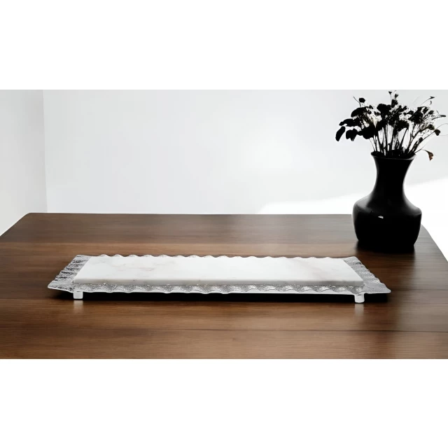 white silver rectangular marble serving tray on wooden table with plant and vase