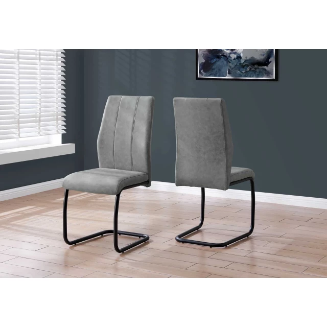 Black metal polyester dining chairs with wood accents near a window and grey window blinds
