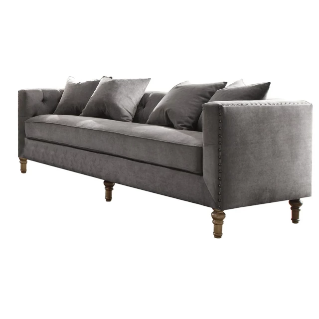 Gray velvet upholstery sofa with pillows and comfortable studio couch design