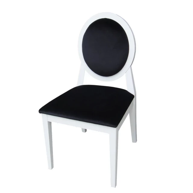 White lacquer black fabric side chairs with wood table and plant
