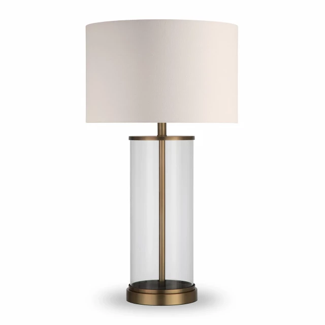 glass table lamp with white drum shade on wooden table with plant