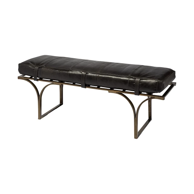 Antiqued brass upholstered genuine leather bench in outdoor setting