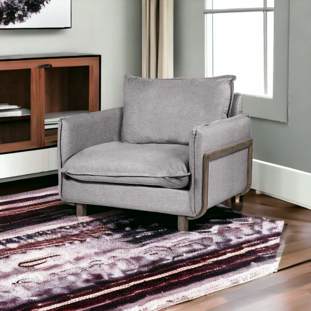 Gray wood brown linen arm chair in a cozy living room setting with comfortable textiles and wooden furniture elements