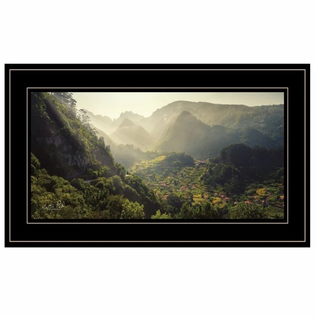Black framed print of a natural landscape with clouds sky and mountains