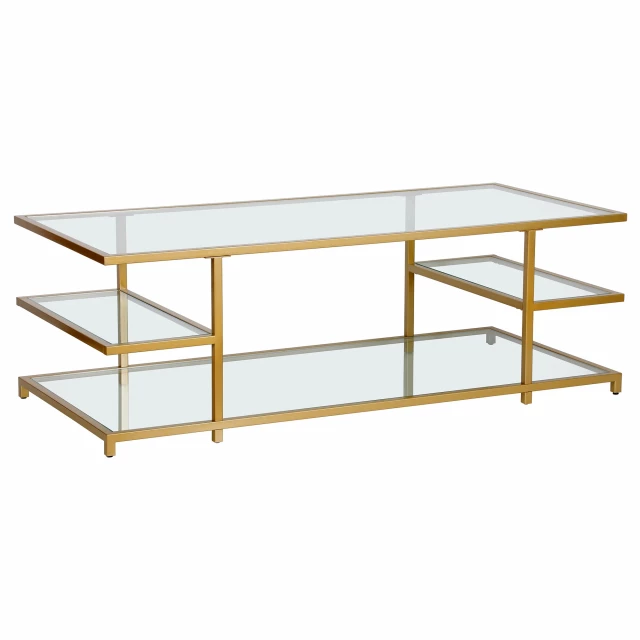 Gold glass steel coffee table with shelves and wood accents in an outdoor setting