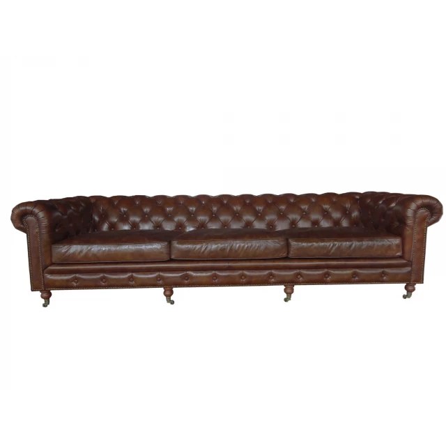 Brown leather sofa with wood accents in a studio couch style offering comfort and a touch of outdoor elegance