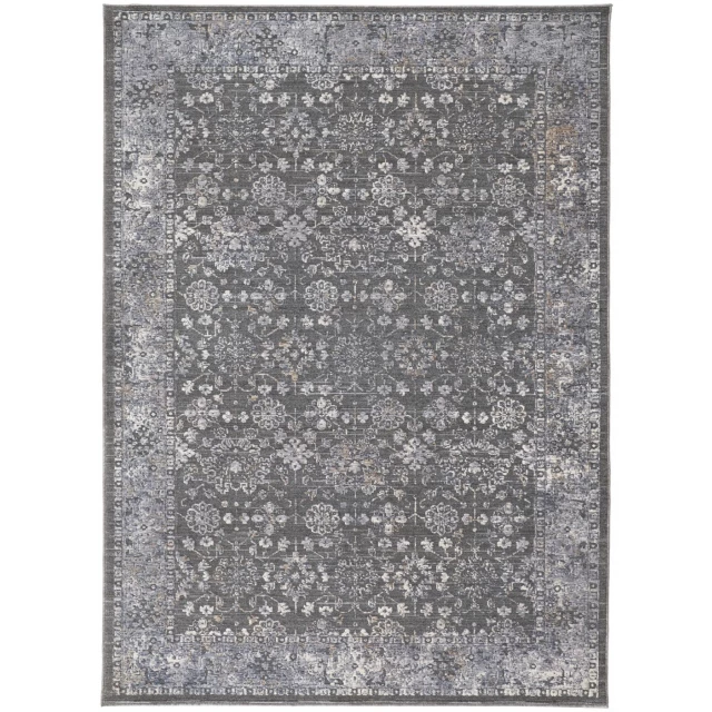 orange floral power loom area rug with grey rectangle pattern on concrete surface