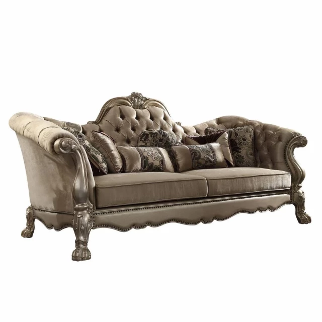 Velvet gold studio couch with seven toss pillows and hardwood details