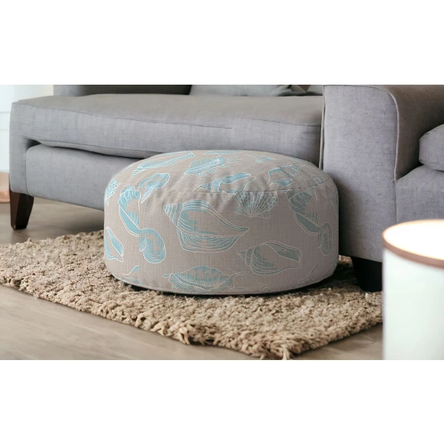 Blue canvas round seashell pouf cover in a comfortable textile design with grey flooring background