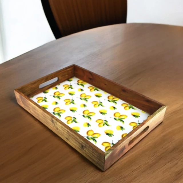 solid wood lemon serving tray with handles on a rectangular hardwood table