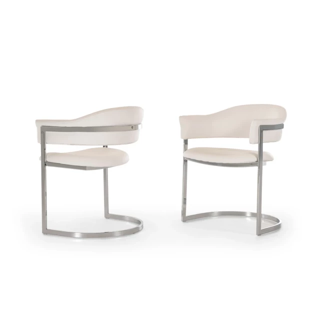 White leatherette stainless steel dining chair with armrests and wood flooring background
