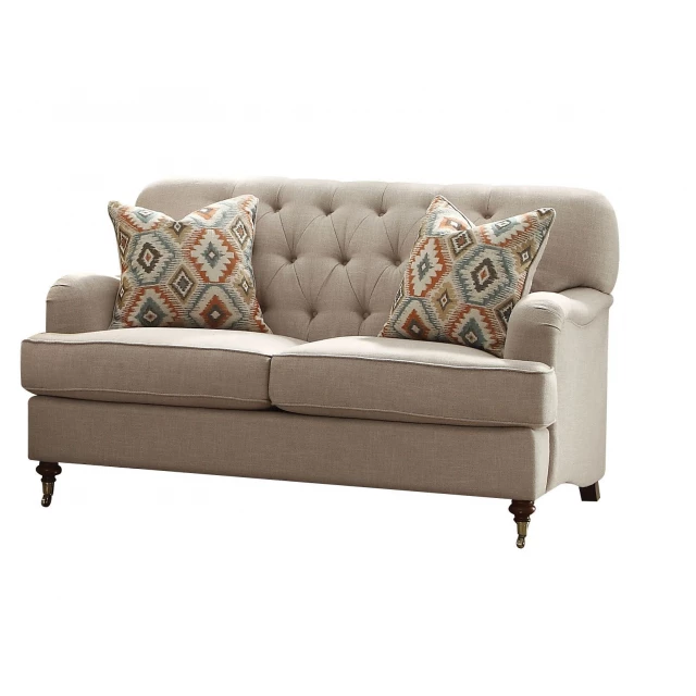 Brown linen curved loveseat with toss pillows for outdoor furniture setting