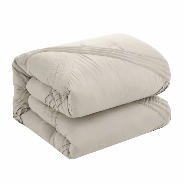Beige polyester thread count washable down comforter on bed with cozy linens
