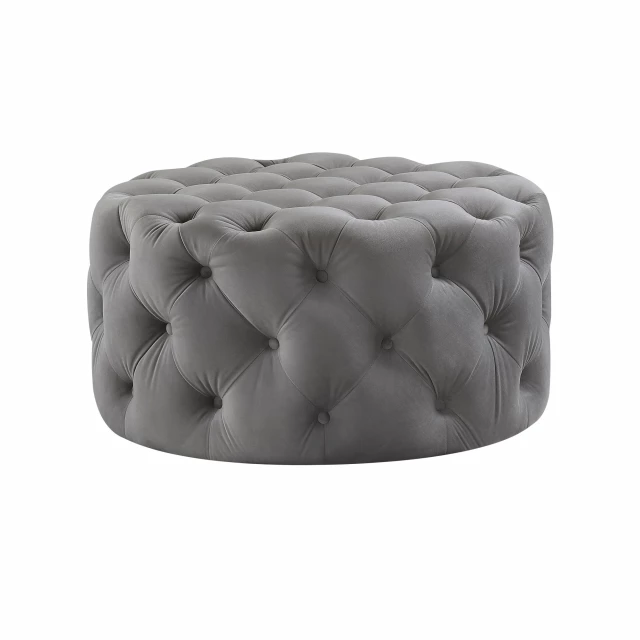 Black rolling tufted round cocktail ottoman with synthetic rubber detail