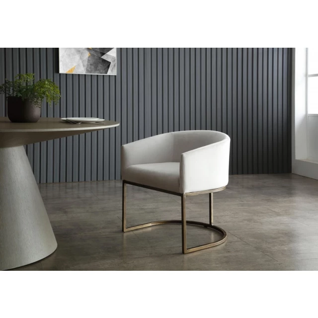 White velvet brass modern dining chair with plant and wood elements