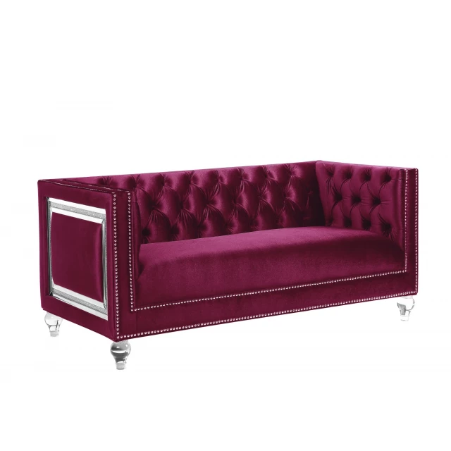Burgundy silver velvet loveseat with toss pillows in a comfortable studio couch design