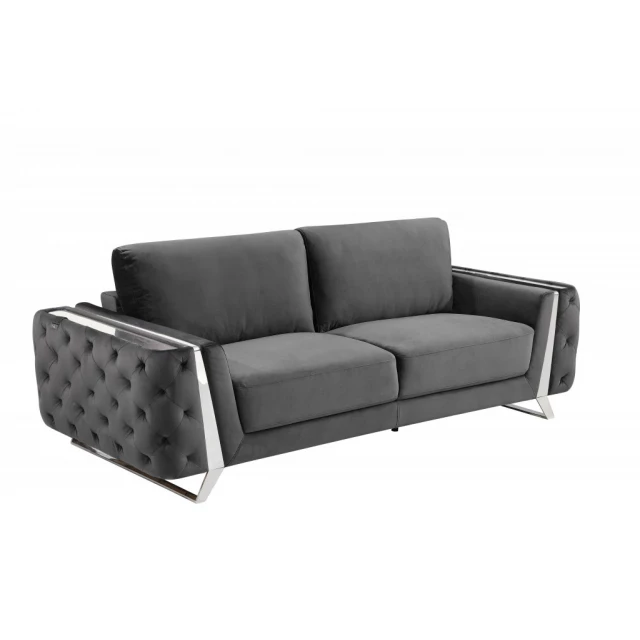Gray silver sofa with armrests and comfortable studio couch design in a furniture setting