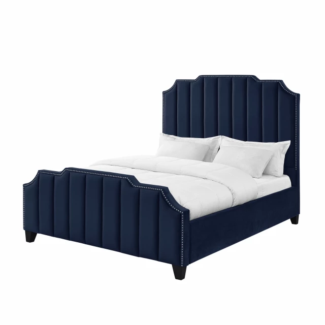 Tufted upholstered velvet bed with nailhead trim in elegant bedroom setting