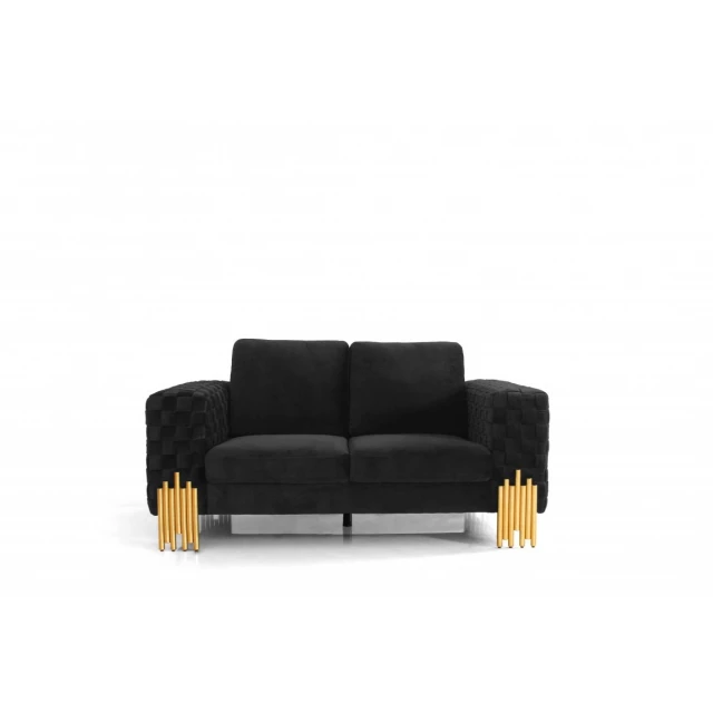 Stylish black velvet loveseat with gold accents and comfortable pillows