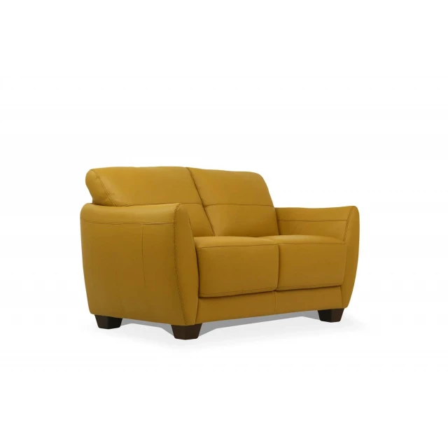 Mustard leather black love seat with comfortable armrests and wooden flooring