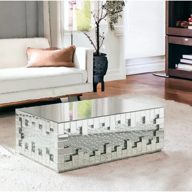 Silver glass mirrored coffee table with wood accents in modern interior design