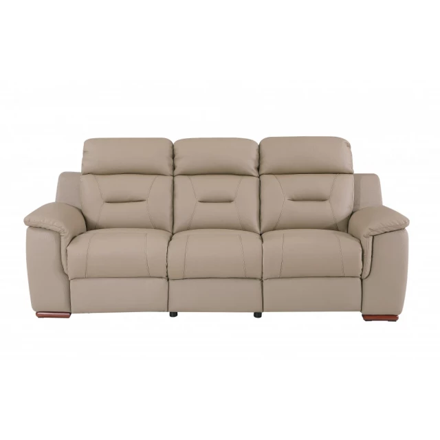 Beige brown faux leather sofa in a comfortable studio setting with wooden accents