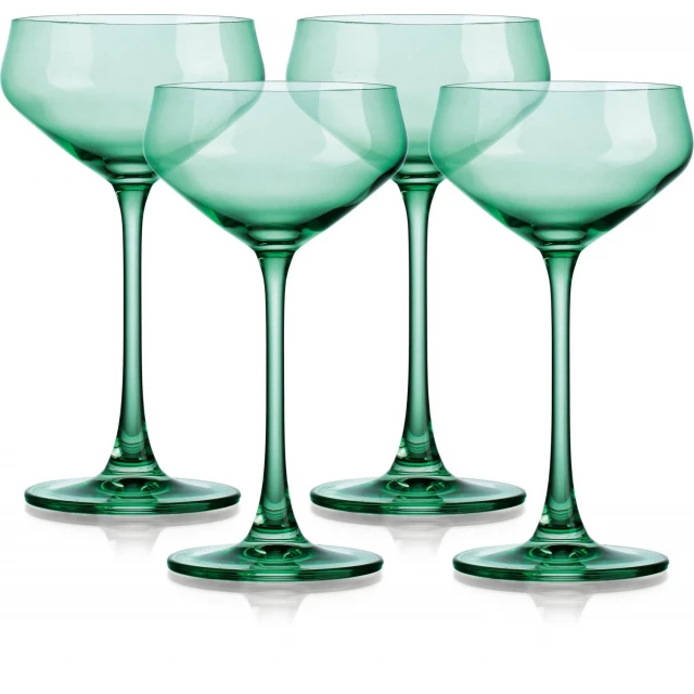 four translucent pale green coupe glasses drinkware stemware on table