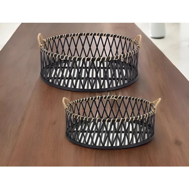 tan round bamboo serving tray with handles on wooden table