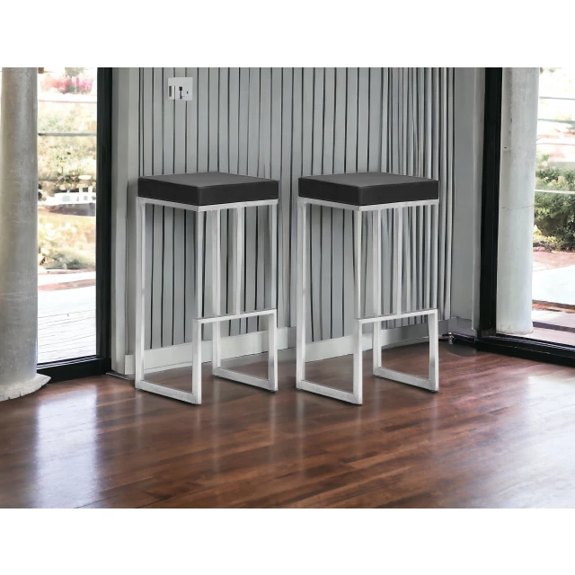 Steel backless bar height chairs with wood and laminate flooring background