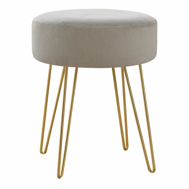 Beige velvet gold round ottoman with metallic accents in a luxurious fashion style