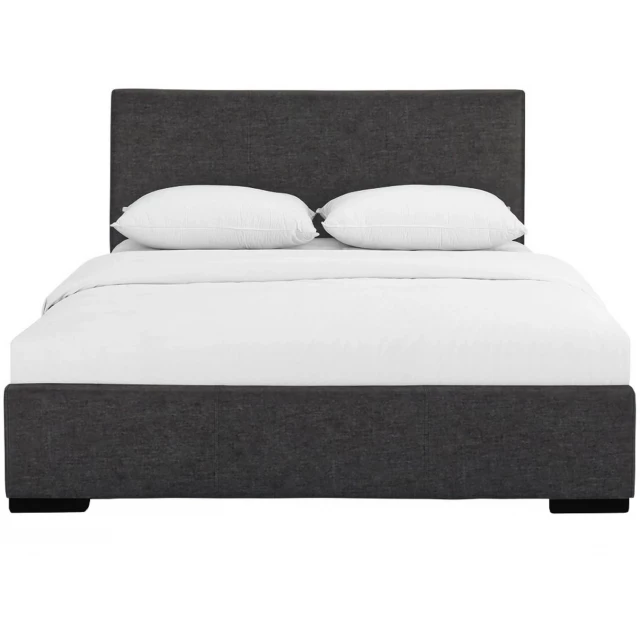 Grey upholstered queen platform bed in a modern bedroom setting